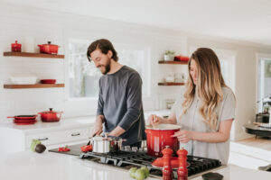 Couple enjoying a conversation as they prepare a meal.