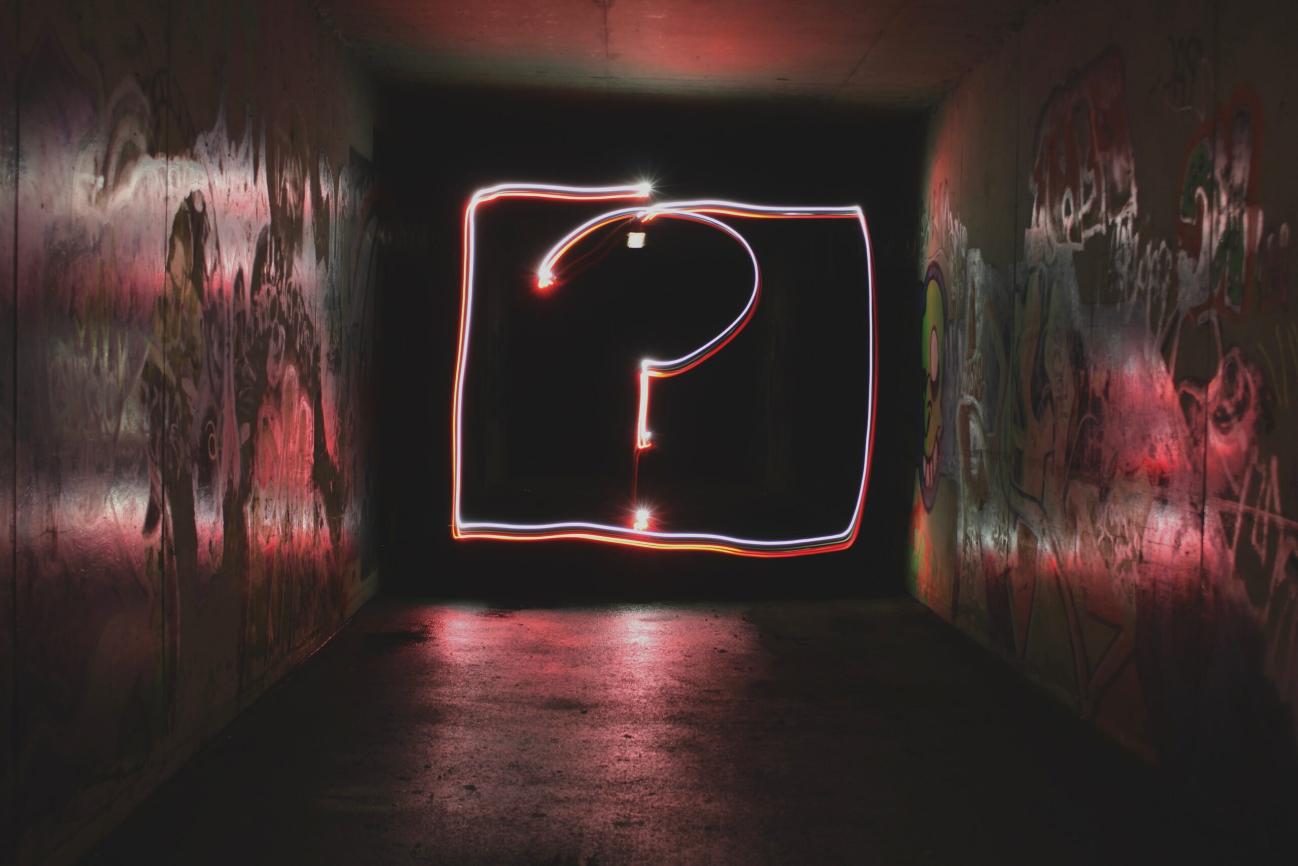 Neon sign of a question mark.