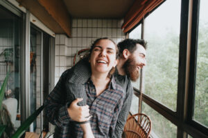 Couple playfully embracing and laughing.