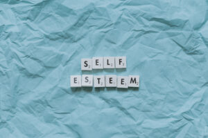 Self-esteem spelled out in scrabble tiles.