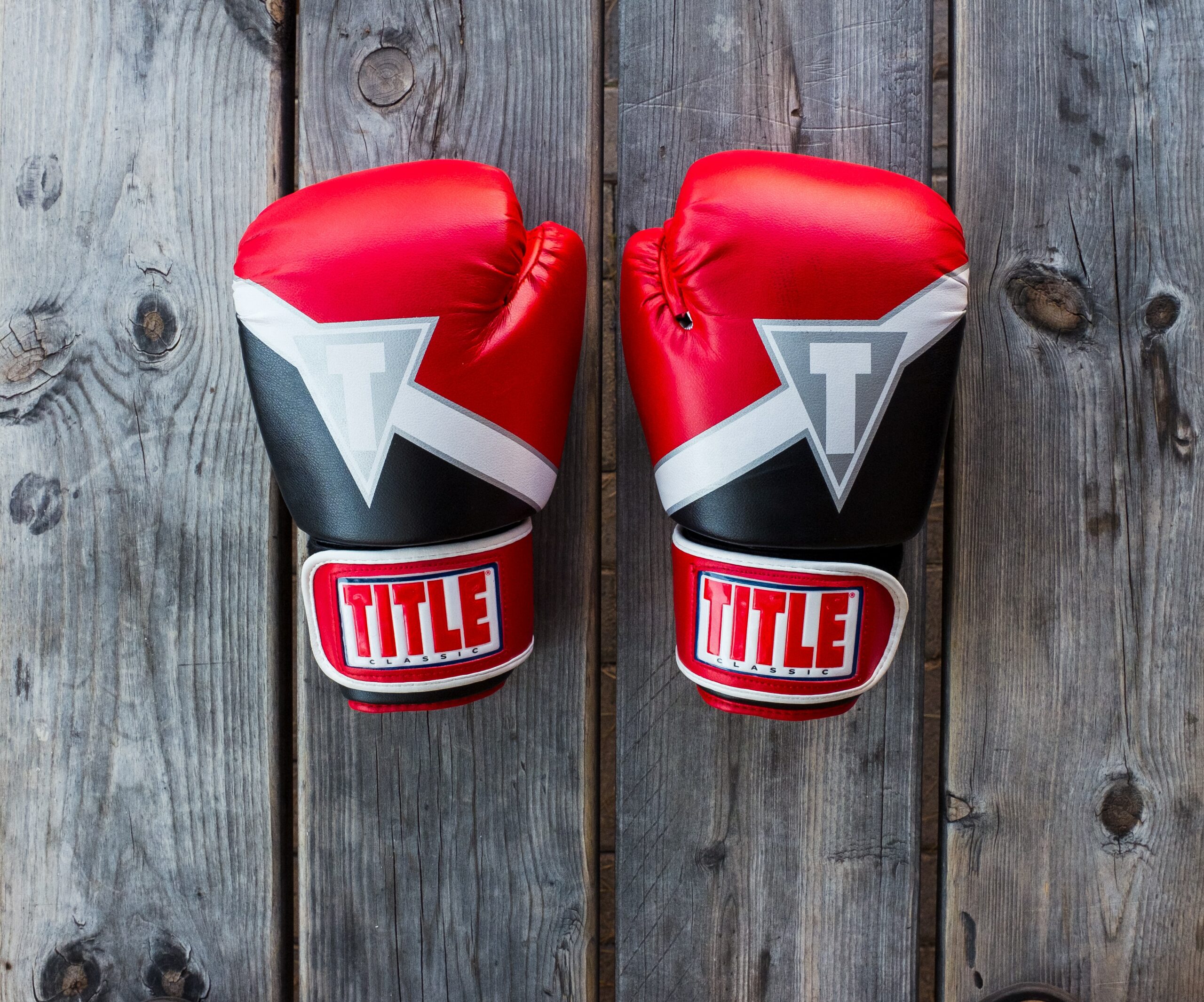 Black and white boxing gloves on a wooden deck symbolize not arguing.