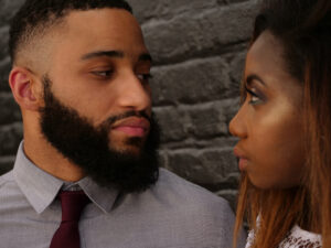 Serious couple looking at each other as they contemplate fighting for their marriage.