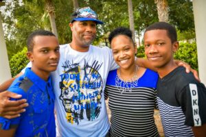 A smiling family of four as a result of what a husband can change to make life better.