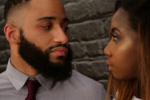 Couple looking at each other wondering why they are no longer feel connected in their marriage.